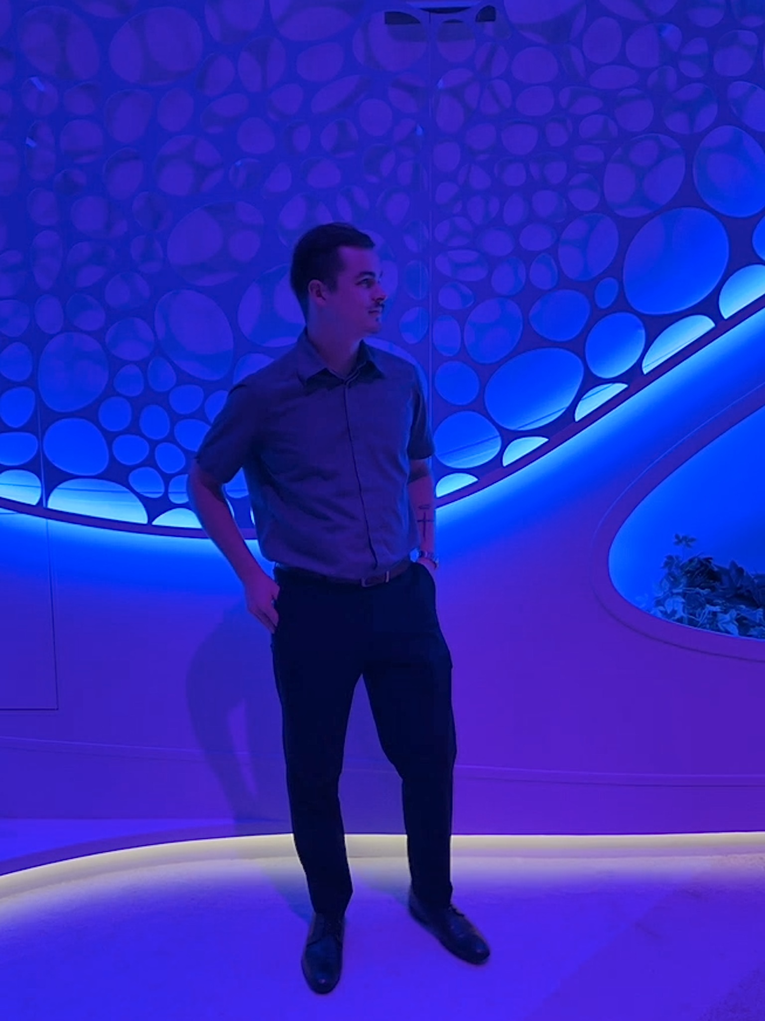 Josh Czarnecki standing in front of a blue and purple illuminated wall